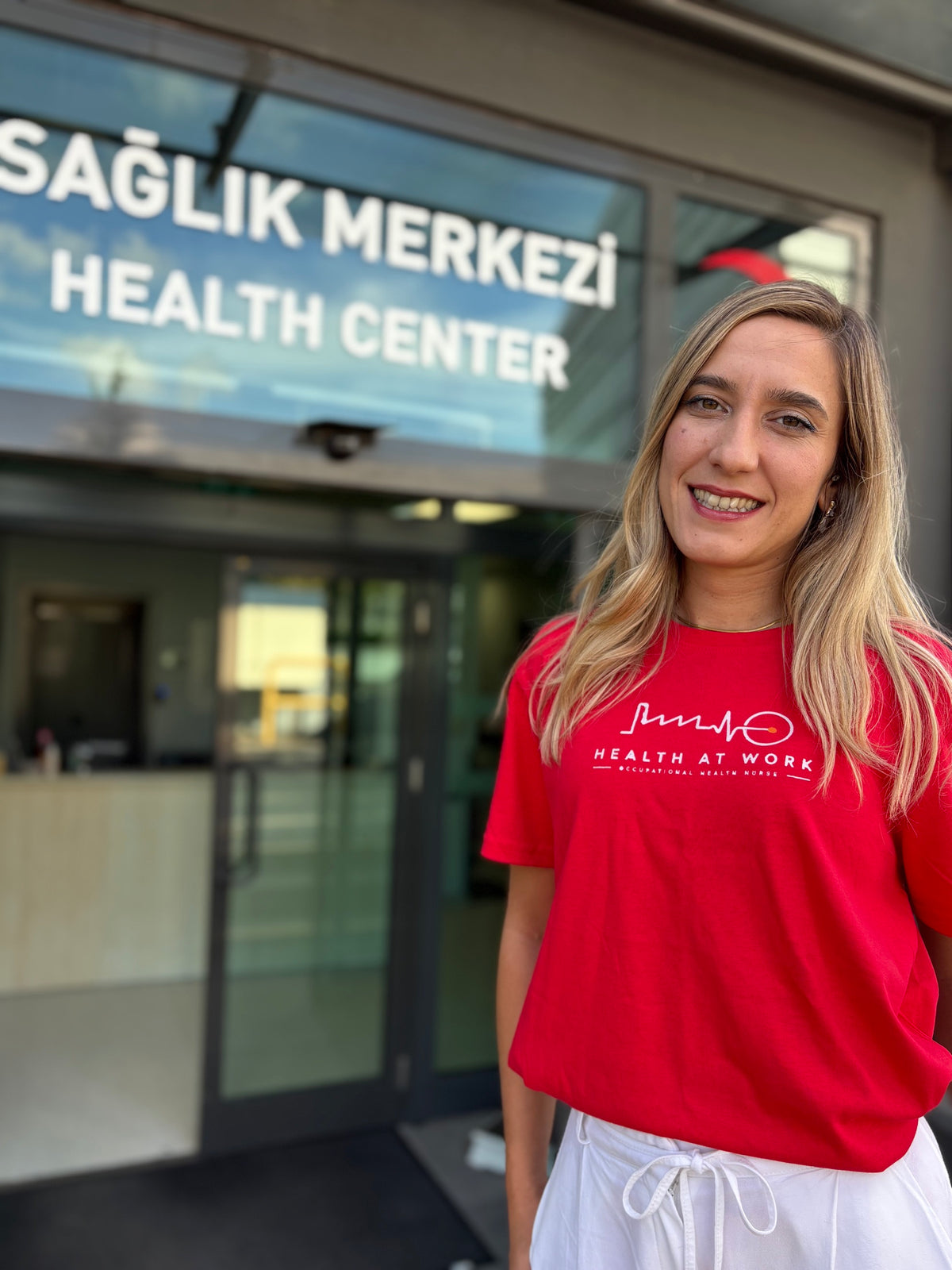 Occupational health nurse in front of a health center